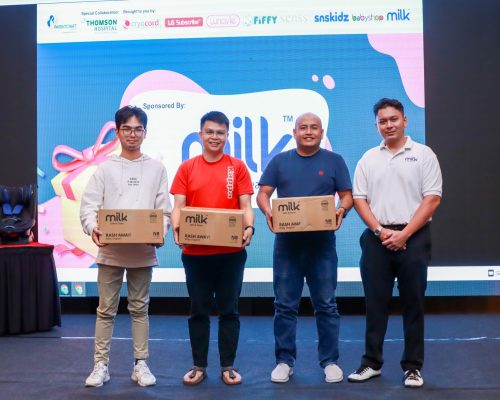 3 winners holding a box of diapers