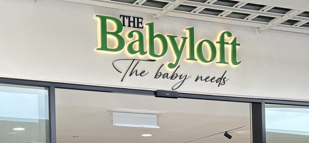The Babyflot store in the Elmina Mall, highlighting its vibrant signage and a variety of baby items in the window display.