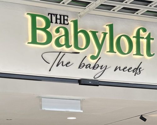 The Babyflot store in the Elmina Mall, highlighting its vibrant signage and a variety of baby items in the window display.