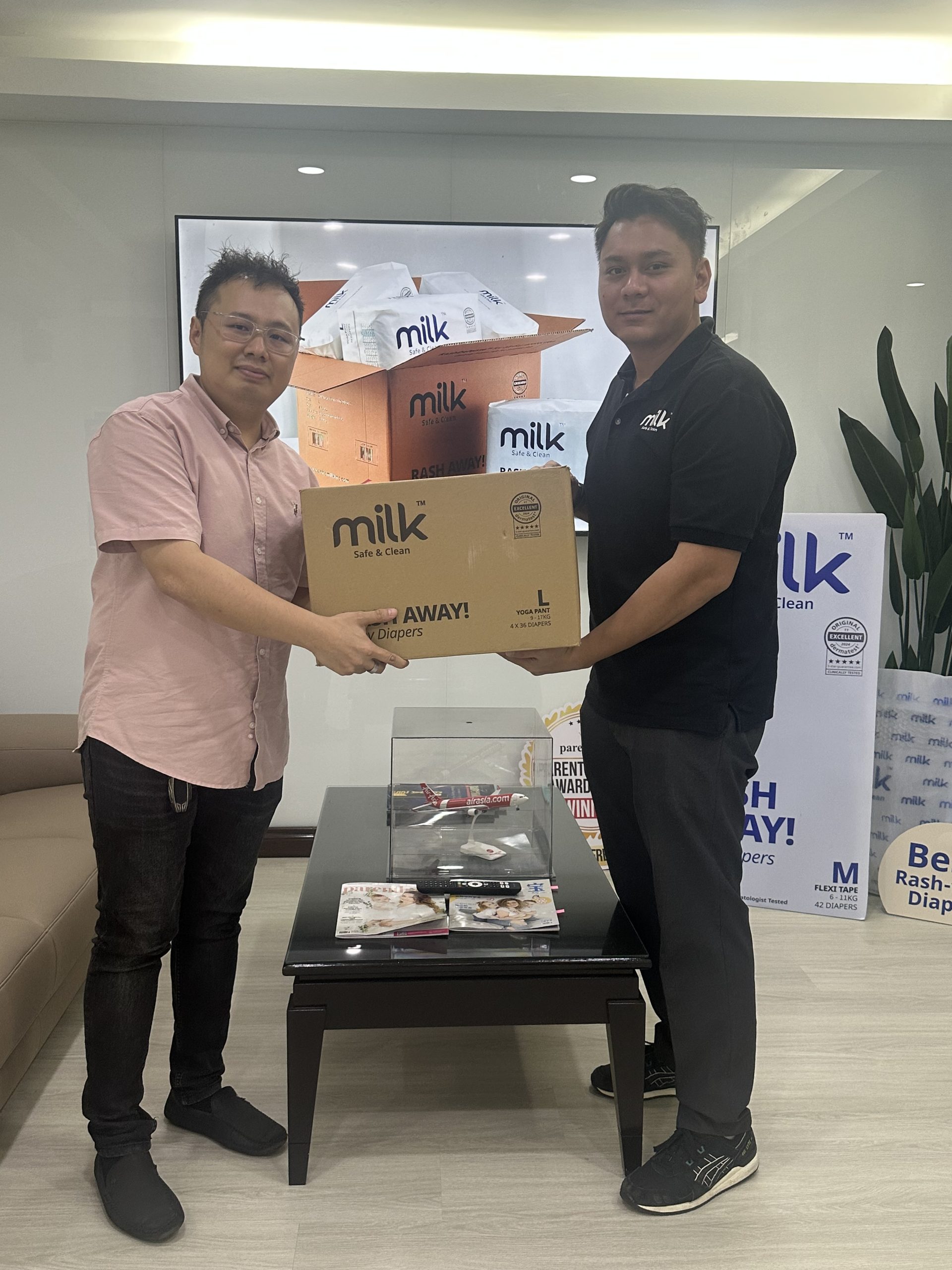Man holding MILK boxes with customer