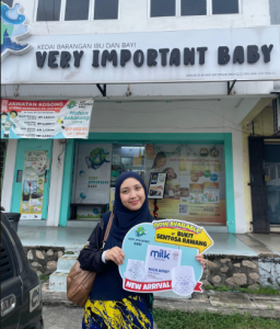Mom holding a baby diaper sign
