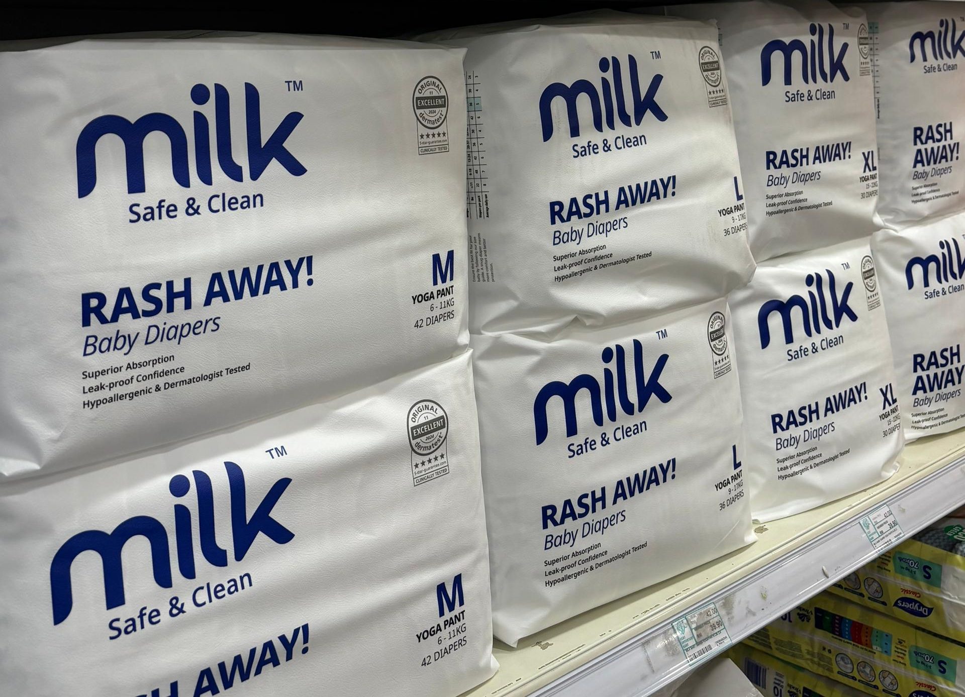 Shelf of MILK baby diapers in baby store