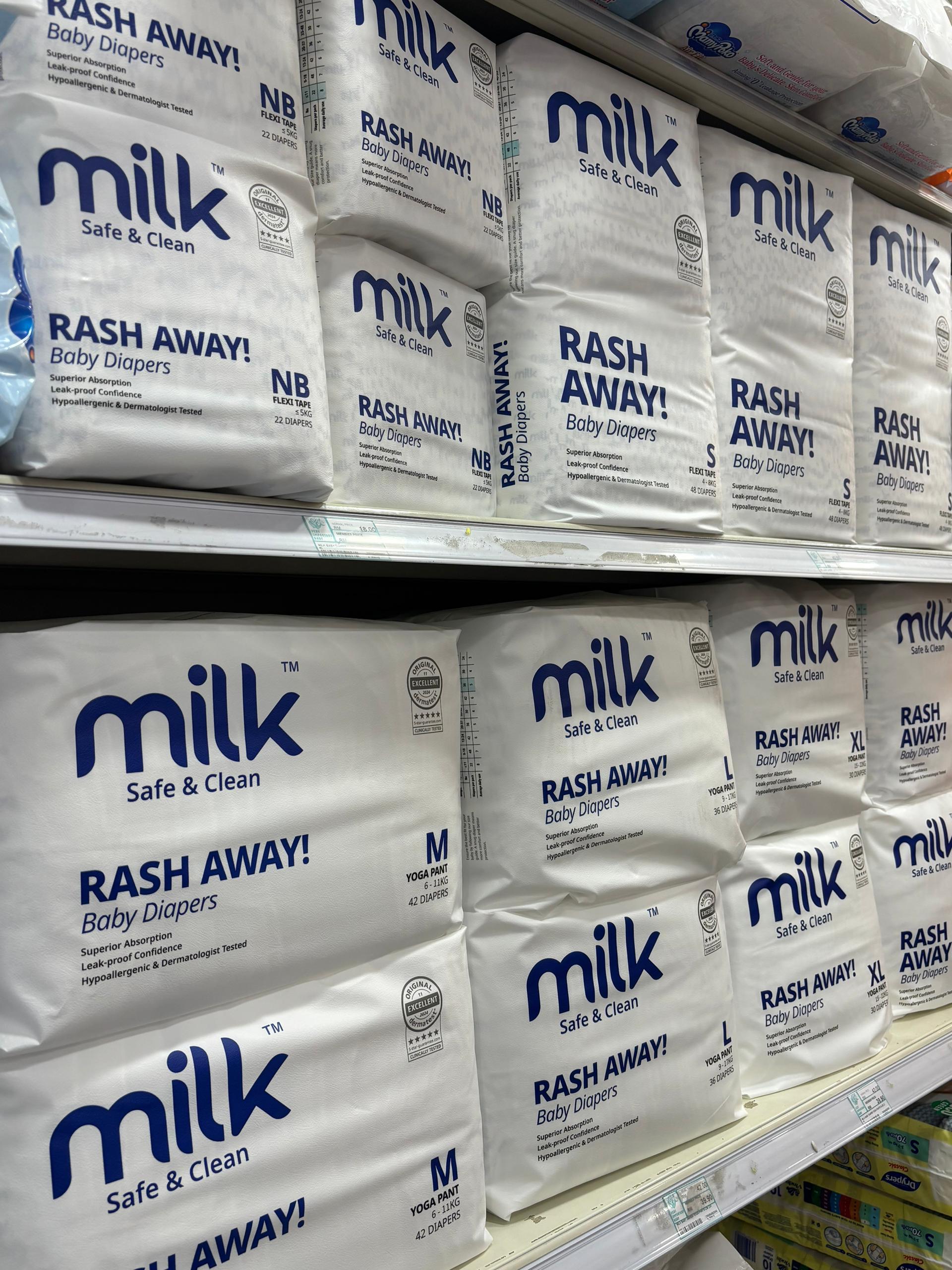 Shelf of MILK baby diapers in baby store