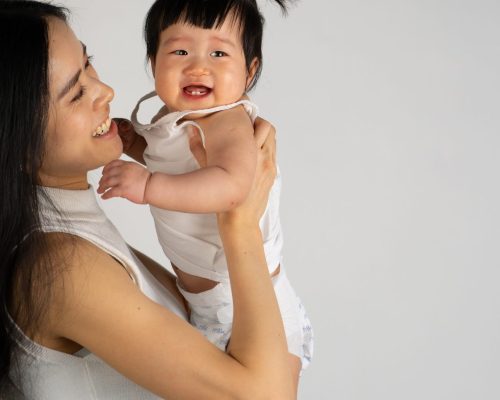 Happy mum holding her child